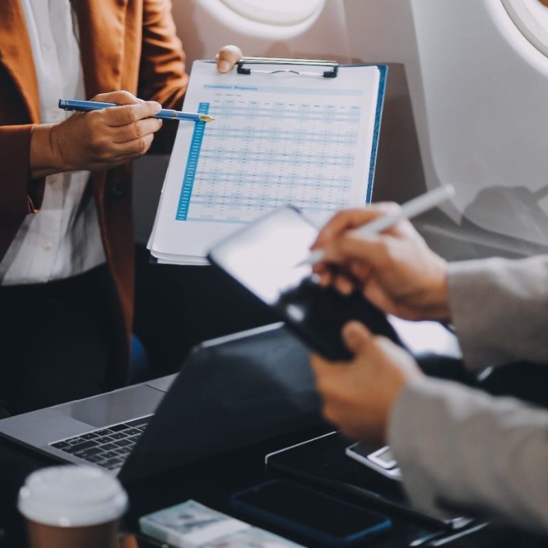 business-people-meeting-private-plane-asian-businessman-suit-is-talking-woman-jet-pointing-blank-laptop-screen-colleagues-are-discussing-deal-flying-plane (1)